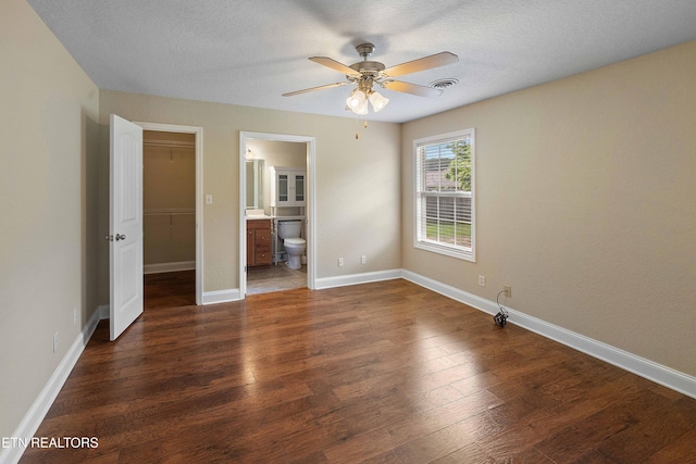 4411 Waldon Pond, Corryton, TN 37721 - unfurnished bedroom featuring a spacious closet, wood finished floors, a closet, baseboards, and a textured ceiling