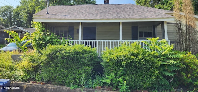 378 Church St, Jellico, TN 37762 - view of home's exterior with roof with shingles, a chimney, and a sunroom