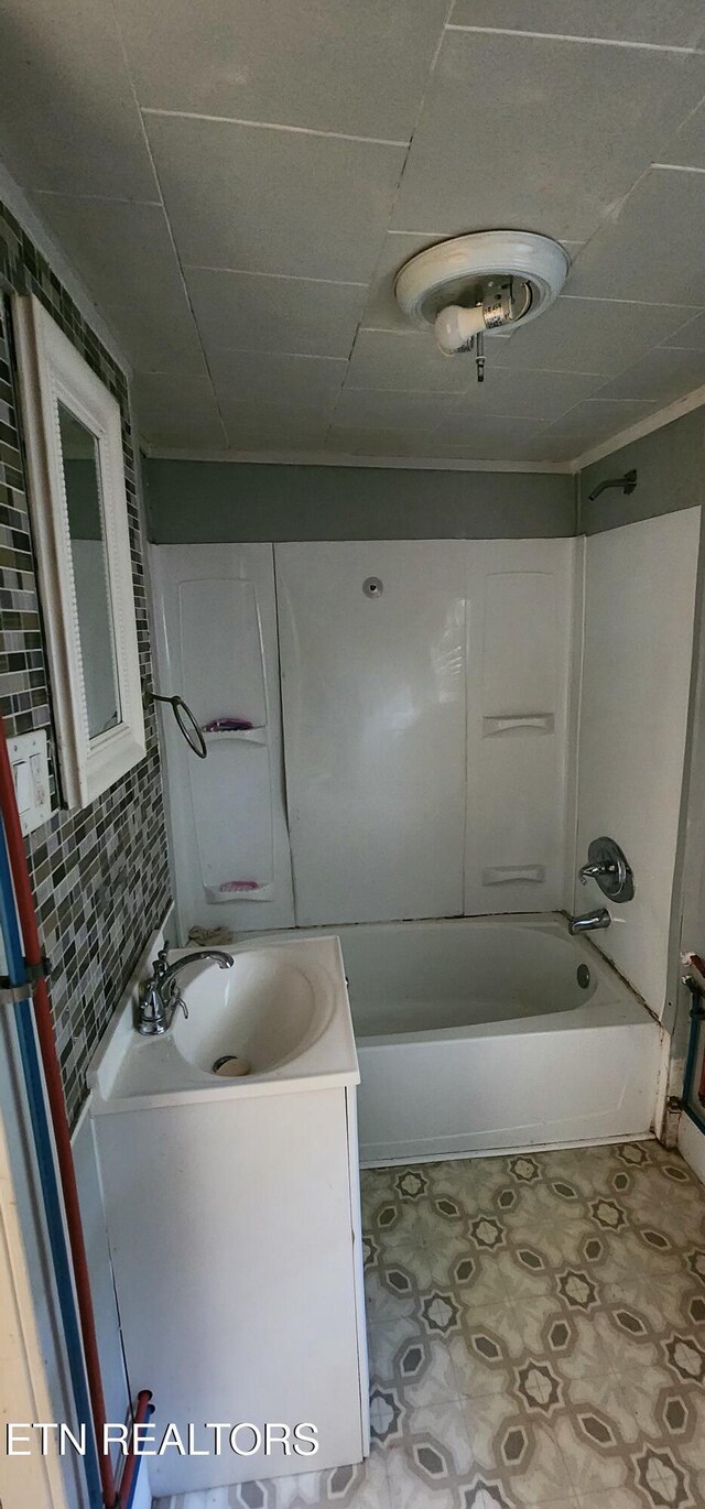 378 Church St, Jellico, TN 37762 - bathroom with vanity, washtub / shower combination, and tile patterned floors