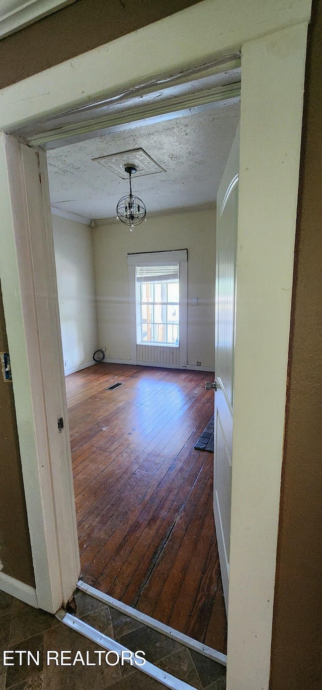 378 Church St, Jellico, TN 37762 - empty room with hardwood / wood-style flooring and a textured ceiling