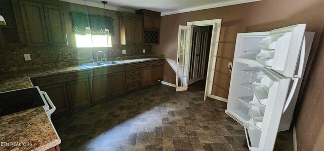 378 Church St, Jellico, TN 37762 - kitchen with dark stone finish flooring, crown molding, decorative backsplash, range, and decorative light fixtures
