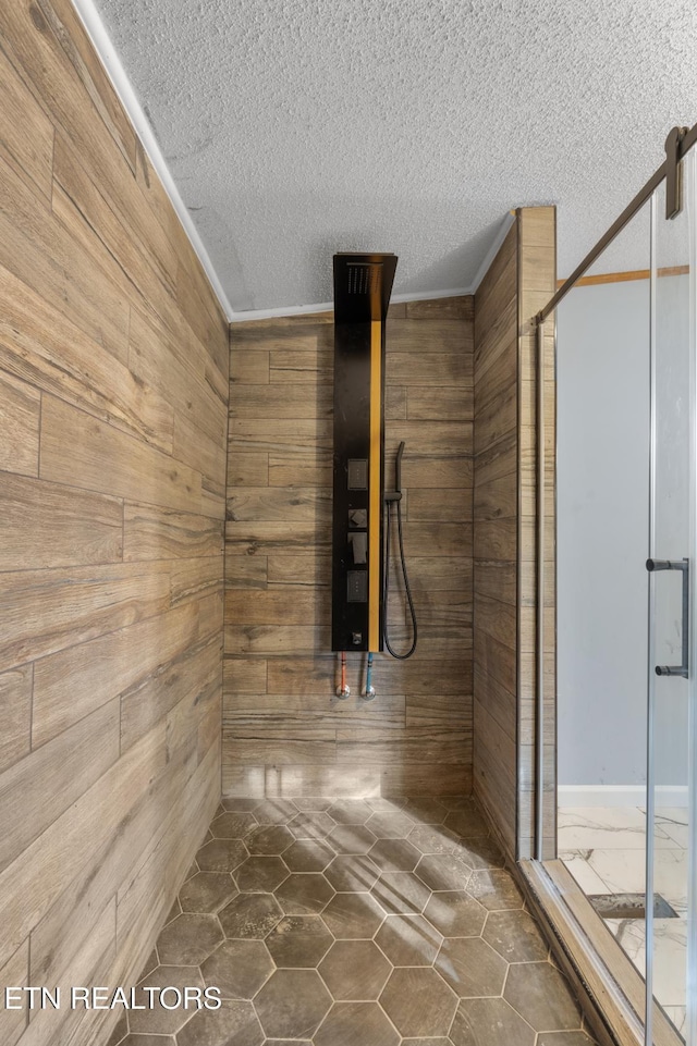 1477 Womac Hollow Rd, Ten Mile, TN 37880 - bathroom with wood walls, a textured ceiling, a shower stall, crown molding, and tile patterned floors
