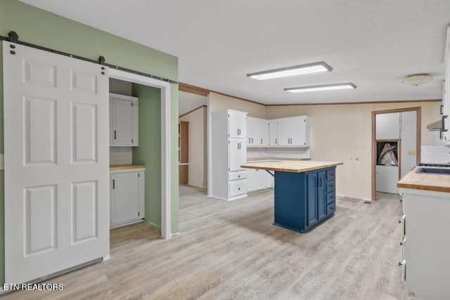 1477 Womac Hollow Rd, Ten Mile, TN 37880 - kitchen with blue cabinets, wood counters, backsplash, light wood-type flooring, and white cabinetry