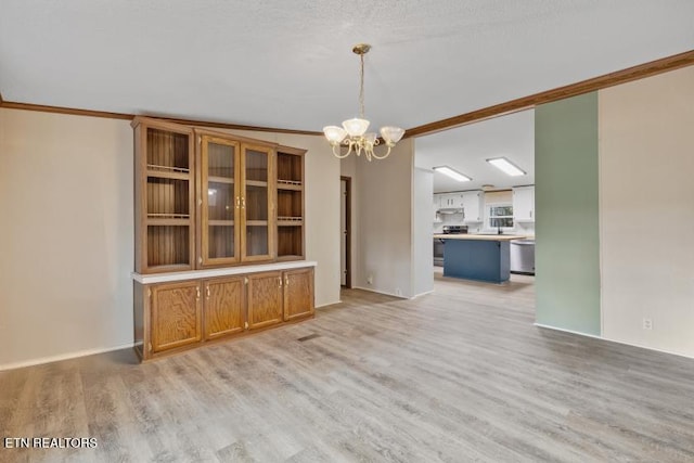 1477 Womac Hollow Rd, Ten Mile, TN 37880 - unfurnished dining area featuring crown molding, a chandelier, and light wood-type flooring