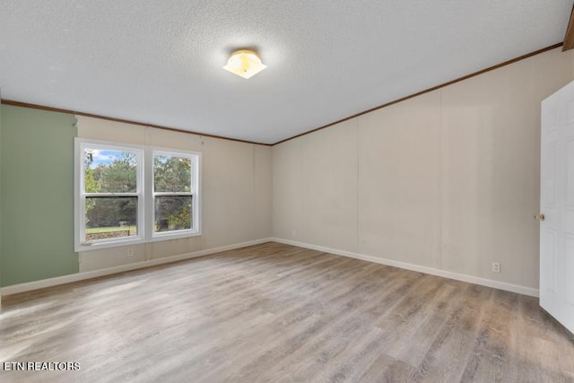 1477 Womac Hollow Rd, Ten Mile, TN 37880 - unfurnished room featuring wood finished floors, baseboards, ornamental molding, and a textured ceiling