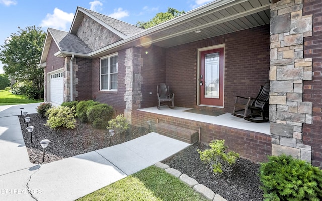 6305 Glen Eagle Ln, Knoxville, TN 37921 - entrance to property with brick siding, covered porch, a garage, roof with shingles, and driveway