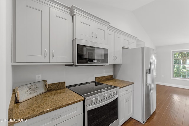 6305 Glen Eagle Ln, Knoxville, TN 37921 - kitchen featuring stainless steel appliances, vaulted ceiling, dark wood-style flooring, light stone countertops, and baseboards