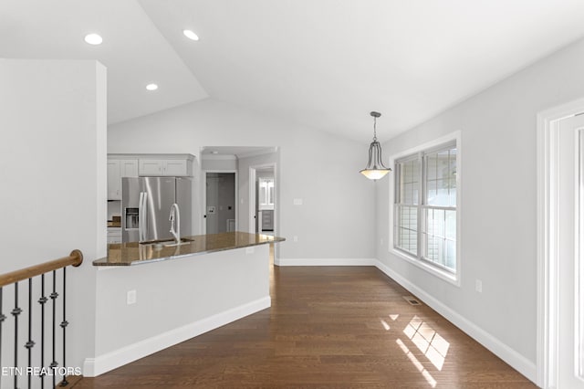 6305 Glen Eagle Ln, Knoxville, TN 37921 - kitchen with stainless steel fridge with ice dispenser, lofted ceiling, dark wood-style floors, dark stone countertops, and baseboards