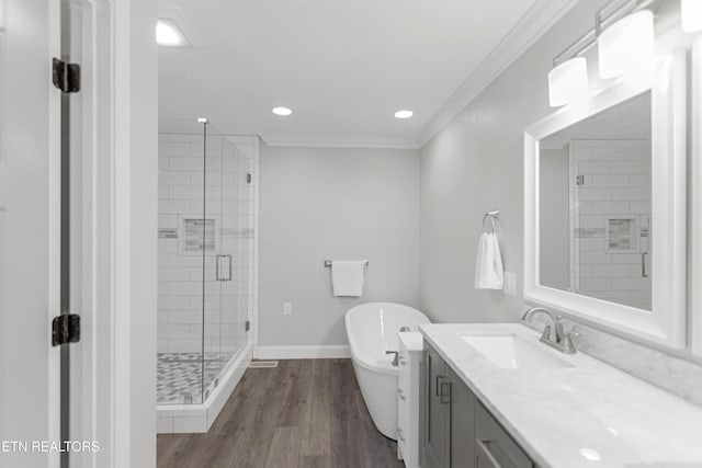 6305 Glen Eagle Ln, Knoxville, TN 37921 - bathroom featuring a stall shower, ornamental molding, a freestanding tub, vanity, and wood finished floors