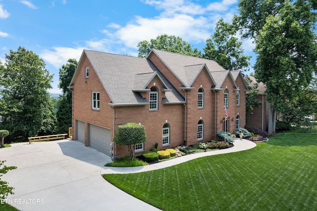 12912 Long Ridge Rd, Knoxville, TN 37934 - view of front of house featuring an attached garage, a front yard, brick siding, concrete driveway, and roof with shingles