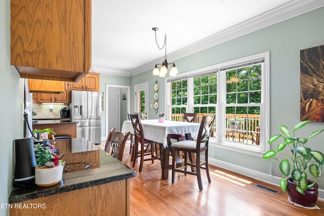 12912 Long Ridge Rd, Knoxville, TN 37934 - dining room with ornamental molding, a chandelier, healthy amount of natural light, light wood-style floors, and baseboards