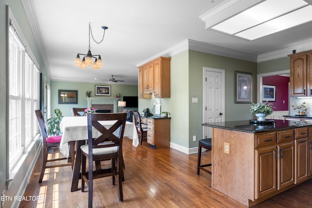 12912 Long Ridge Rd, Knoxville, TN 37934 - kitchen featuring a chandelier, wood finished floors, a fireplace, crown molding, and a kitchen bar