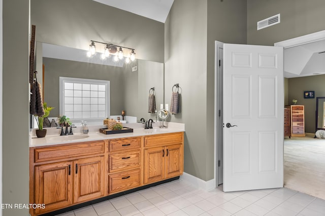 12912 Long Ridge Rd, Knoxville, TN 37934 - bathroom with double vanity, tile patterned floors, baseboards, and high vaulted ceiling