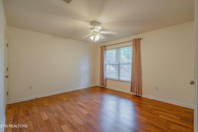 3950 Cherokee Woods Way Unit 105, Knoxville, TN 37920 - empty room with ceiling fan, wood finished floors, and baseboards