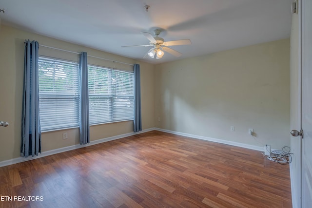 3950 Cherokee Woods Way Unit 105, Knoxville, TN 37920 - empty room with wood finished floors, ceiling fan, and baseboards