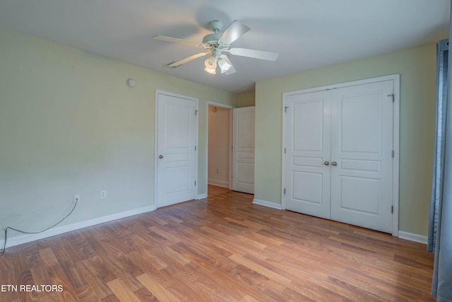 3950 Cherokee Woods Way Unit 105, Knoxville, TN 37920 - unfurnished bedroom with wood finished floors, baseboards, a closet, and ceiling fan