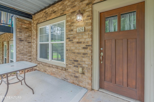 3950 Cherokee Woods Way Unit 105, Knoxville, TN 37920 - property entrance with a porch and brick siding