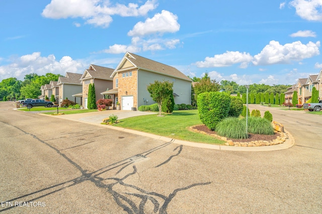 3210 Gazebo Point Way, Knoxville, TN 37920 - view of front facade with an attached garage, driveway, a residential view, a front yard, and stone siding