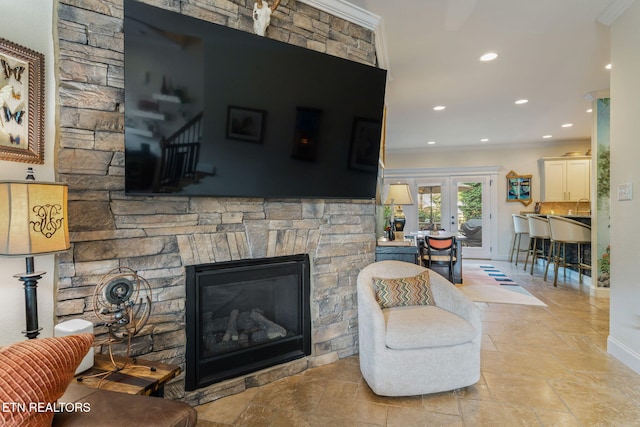 3210 Gazebo Point Way, Knoxville, TN 37920 - living area with a fireplace, baseboards, ornamental molding, recessed lighting, and stone tile flooring