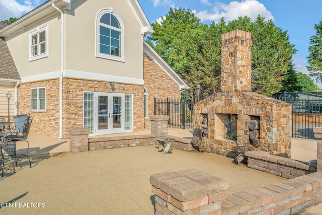 3210 Gazebo Point Way, Knoxville, TN 37920 - view of patio featuring an outdoor stone fireplace and french doors