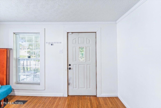 613 Victory St, Knoxville, TN 37919 - entryway with ornamental molding, a textured ceiling, light wood-style floors, and baseboards