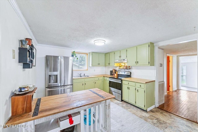 613 Victory St, Knoxville, TN 37919 - kitchen with appliances with stainless steel finishes, green cabinets, under cabinet range hood, a sink, and a textured ceiling