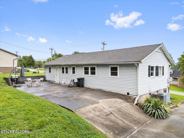 321 Sunrise Dr, Kingston, TN 37763 - back of house featuring cooling unit, a patio area, a yard, and roof with shingles