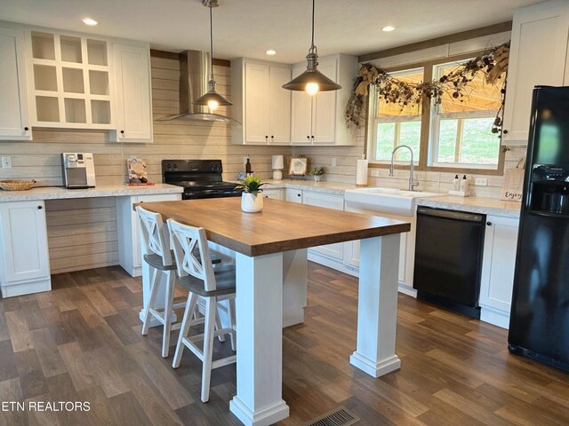 4501 Shipe Rd, Corryton, TN 37721 - kitchen featuring wood counters, wall chimney range hood, black appliances, backsplash, and a kitchen bar