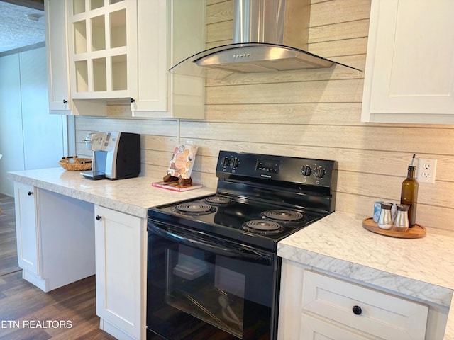 4501 Shipe Rd, Corryton, TN 37721 - kitchen featuring black range with electric stovetop, island exhaust hood, white cabinetry, light countertops, and dark wood-style floors
