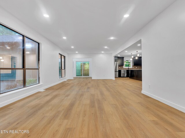 9501 E Aiken Ln, Knoxville, TN 37922 - unfurnished living room featuring light wood-type flooring, baseboards, and recessed lighting