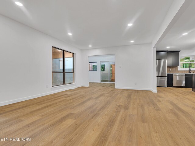 9501 E Aiken Ln, Knoxville, TN 37922 - unfurnished living room with light wood-type flooring, recessed lighting, and baseboards