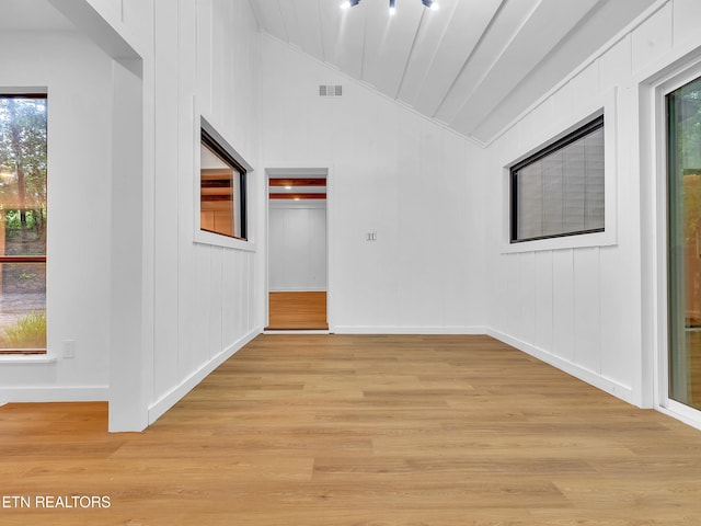 9501 E Aiken Ln, Knoxville, TN 37922 - spare room featuring vaulted ceiling, light wood-style flooring, baseboards, and a decorative wall