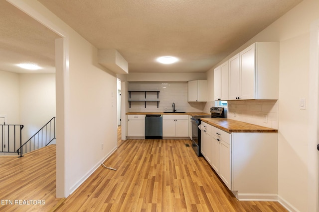 2800 Boyds Bridge Pike, Knoxville, TN 37914 - kitchen with butcher block counters, appliances with stainless steel finishes, a sink, white cabinets, and light wood-style flooring
