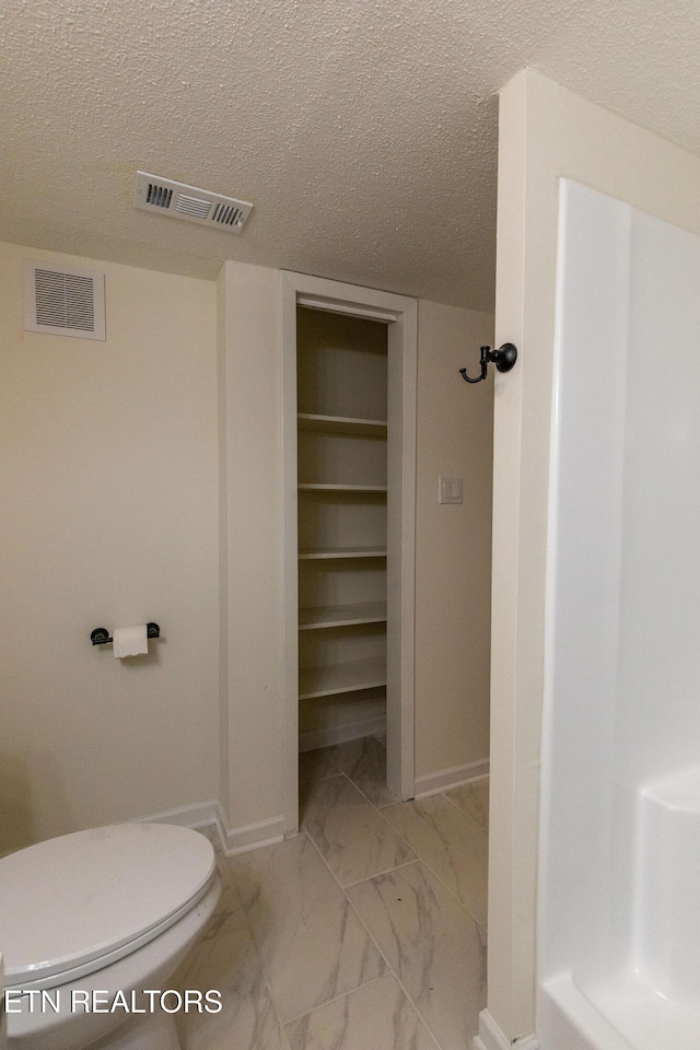 2800 Boyds Bridge Pike, Knoxville, TN 37914 - bathroom with baseboards, a textured ceiling, marble finish flooring, and toilet