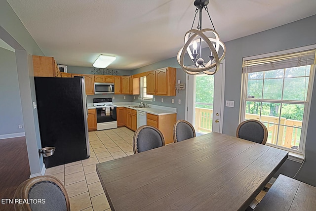 773 Harvest Meadows Dr, Kodak, TN 37764 - kitchen featuring appliances with stainless steel finishes, a sink, light countertops, a chandelier, and light tile patterned flooring