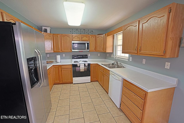 773 Harvest Meadows Dr, Kodak, TN 37764 - kitchen featuring appliances with stainless steel finishes, a sink, light tile patterned flooring, and light countertops