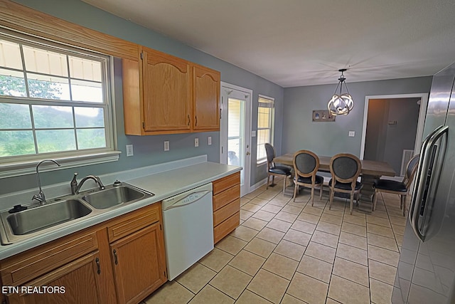 773 Harvest Meadows Dr, Kodak, TN 37764 - kitchen featuring white dishwasher, a sink, light tile patterned floors, light countertops, and plenty of natural light