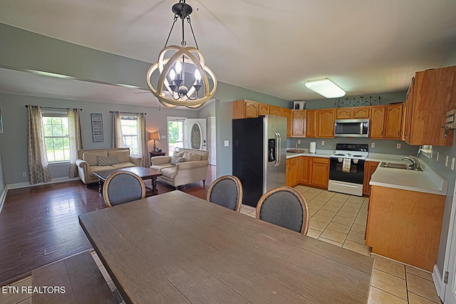 773 Harvest Meadows Dr, Kodak, TN 37764 - kitchen featuring appliances with stainless steel finishes, a sink, light countertops, open floor plan, and healthy amount of natural light