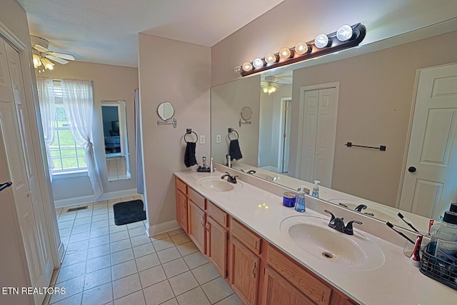 773 Harvest Meadows Dr, Kodak, TN 37764 - bathroom featuring ceiling fan, tile patterned floors, double vanity, and baseboards