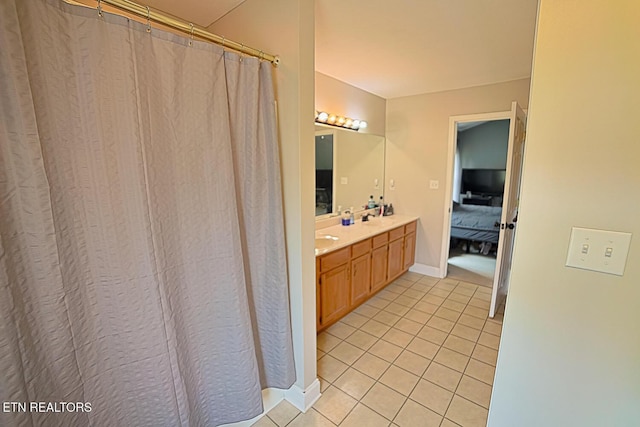 773 Harvest Meadows Dr, Kodak, TN 37764 - ensuite bathroom with tile patterned floors, double vanity, baseboards, and a shower with shower curtain