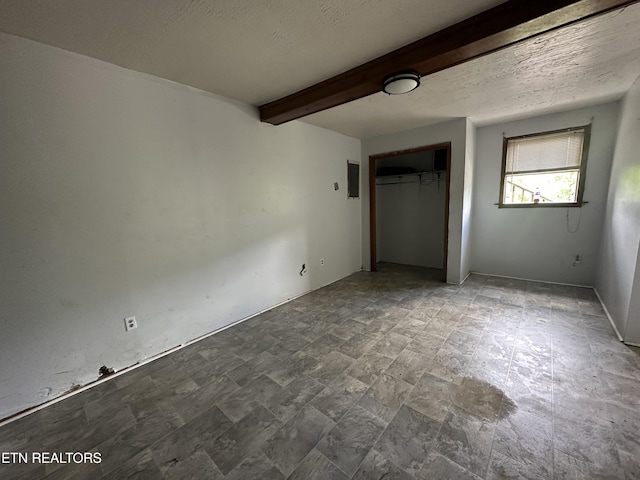 1377 Dr Thomas Walker Rd, Ewing, VA 24248 - unfurnished bedroom with beamed ceiling, a closet, and a textured ceiling