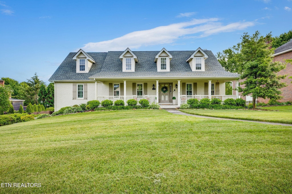 3311 Berkshire Cir, Johnson City, TN 37604 - cape cod house with covered porch, brick siding, a front lawn, and roof with shingles