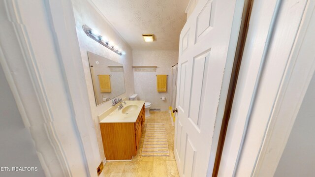 103 Mayfield Dr Unit 5, Elizabethton, TN 37643 - bathroom with vanity, toilet, and a textured ceiling