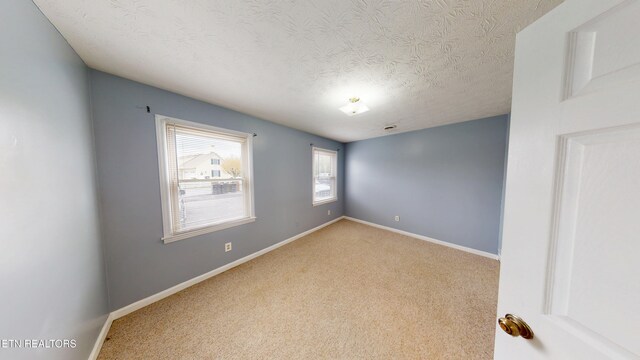 103 Mayfield Dr Unit 5, Elizabethton, TN 37643 - carpeted empty room featuring a textured ceiling and baseboards