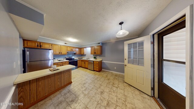 103 Mayfield Dr Unit 5, Elizabethton, TN 37643 - kitchen featuring stainless steel appliances, light countertops, baseboards, brown cabinetry, and a peninsula