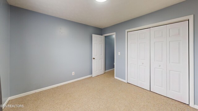 103 Mayfield Dr Unit 5, Elizabethton, TN 37643 - unfurnished bedroom with carpet flooring, baseboards, and a closet