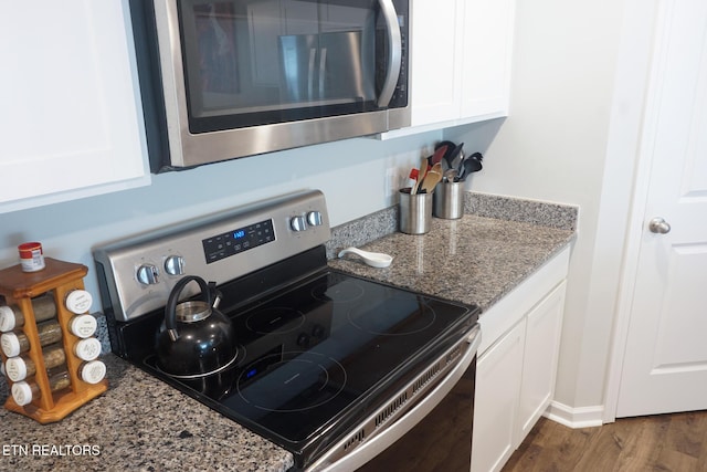 5049 Cottonseed Way, Morristown, TN 37813 - kitchen featuring appliances with stainless steel finishes, white cabinets, wood finished floors, and light stone countertops