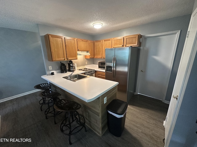 365 Moytoy Rd Unit 103, Crab Orchard, TN 37723 - kitchen featuring stainless steel appliances, dark wood-type flooring, a peninsula, a textured ceiling, and under cabinet range hood