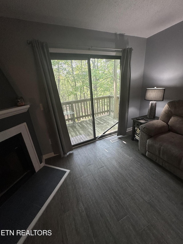 365 Moytoy Rd Unit 103, Crab Orchard, TN 37723 - living room with a textured ceiling, wood finished floors, and a fireplace
