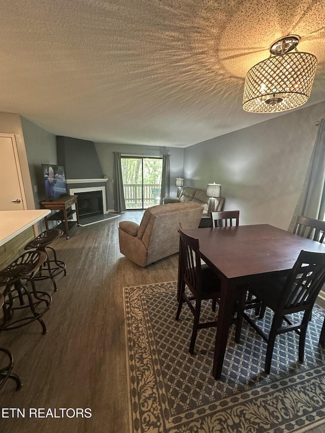 365 Moytoy Rd Unit 103, Crab Orchard, TN 37723 - dining space with dark wood-style flooring, a textured ceiling, and a fireplace